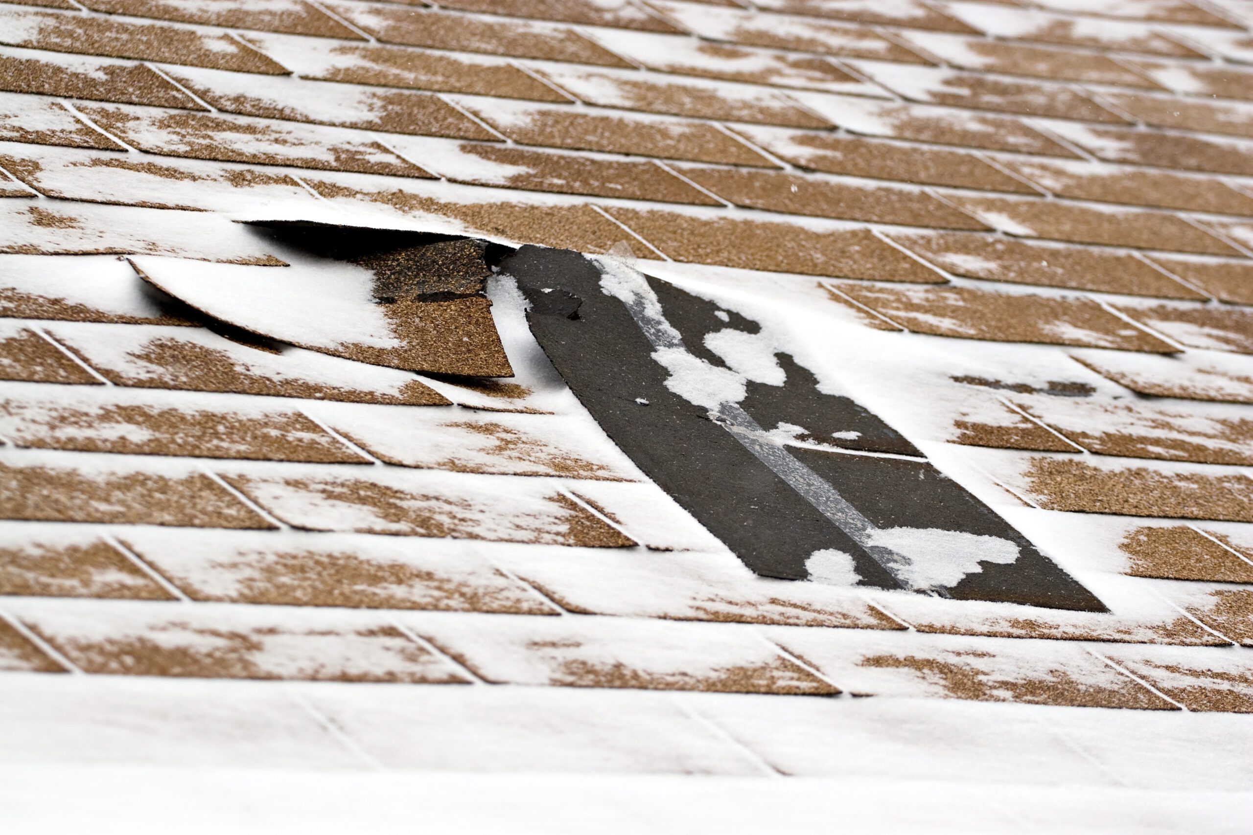 Winter roofing challenges showing snow and ice conditions